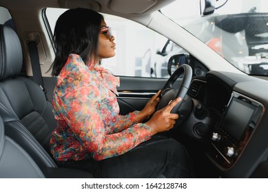 Happy African Woman Driving A New Car