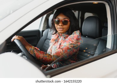 Happy African Woman Driving A New Car