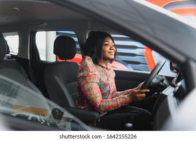 Happy African Woman Driving A New Car