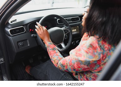 Happy African Woman Driving A New Car