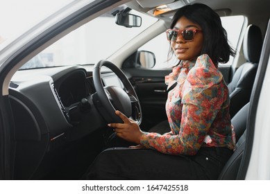 Happy African Woman Driving A New Car