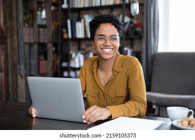 Happy African Woman Freelancer Distracted From Working On Laptop Smile Staring Into Distance, Sit At Workplace Desk Studying Online, Take Remote Professional Training Use Modern Tech, Telework Concept