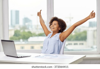 happy african woman with laptop at office