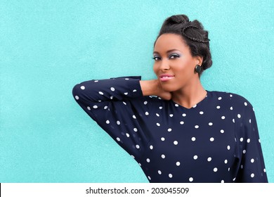 Happy African woman with makeup and hair style updo with braids and copy space - Powered by Shutterstock