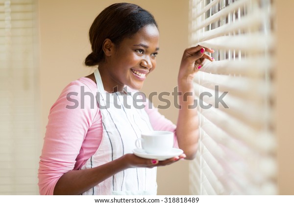 Happy African Woman Peeking Through Blinds Stock Photo 318818489 ...