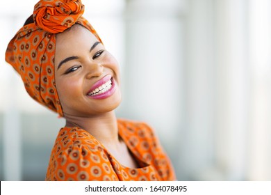 happy african woman wearing traditional attire