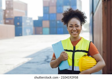 happy African women worker in port cargo shipping industry standing smile.
