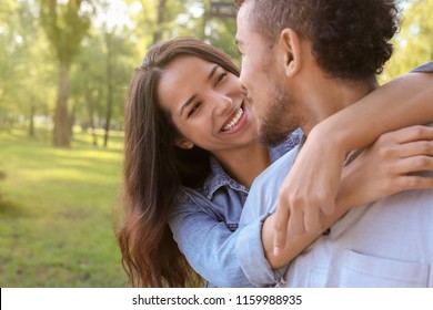 Happy African-American couple in park on spring day