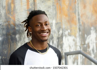 happy African-American Teen Teenager male Man outside in a baseball jersey henley