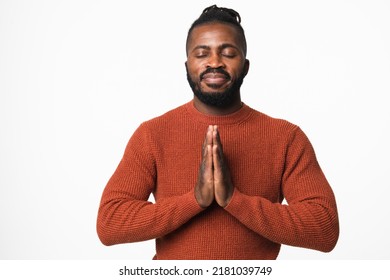 Happy african-american young man meditating praying to God, feeling zen-like, relaxing resting concentrating isolated in white background - Shutterstock ID 2181039749