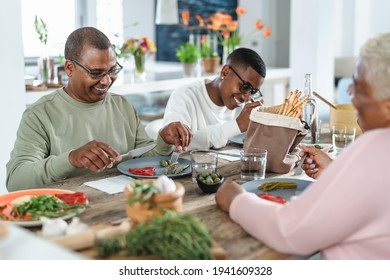 Happy Afro Latin Family Eating Healthy Lunch With Fresh Vegetables At Home - Food And Parents Unity Concept 