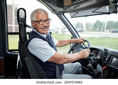 Happy Aged Driver Of Intercity Bus Holding By Steering Wheel During Ride To Another City Or Town
