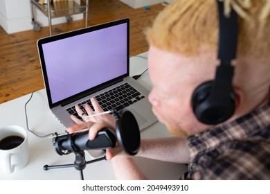 Happy albino african american man with dreadlocks working from home and making podcast. remote working using technology at home. - Powered by Shutterstock