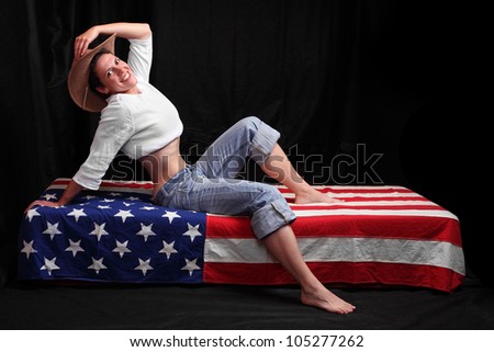 Happy american girl on a flag. Independence day concept.
