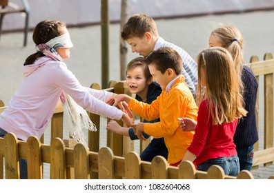 Happy american kids playing at Dead man in street