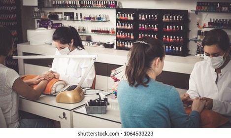 Happy American Women Getting Their Nails Done At Beauty Salon