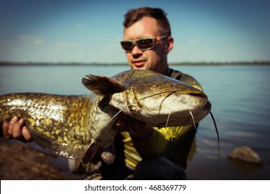 Happy Angler With Catfish Fishing Trophy 