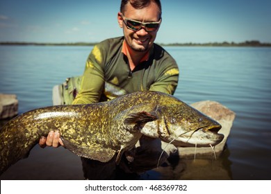 Happy Angler With Catfish Fishing Trophy 