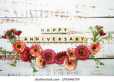 Happy Anniversary Alphabet Letter With Flower Decor On Wooden Background