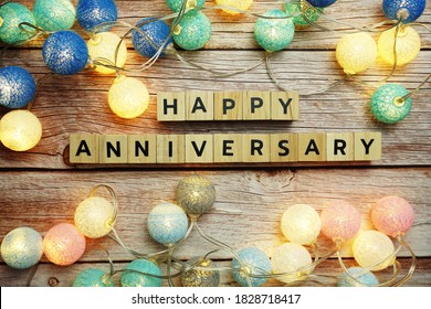 Happy Anniversary alphabet letter with LED cotton balls decoration on wooden background - Shutterstock ID 1828718417