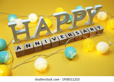 Happy Anniversary Alphabet Letter With LED Cotton Balls On Yellow Background