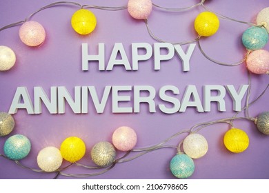 Happy Anniversary alphabet letters with LED Cotton ball Decoration on purple background - Shutterstock ID 2106798605