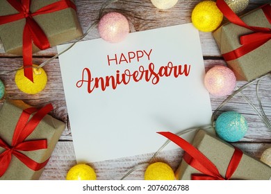 Happy Anniversary Card Typography Text With LED Cotton Ball On Wooden Background