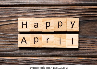 Happy April Word Written On Wood Block. Happy April Text On Table, Concept.