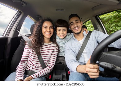 Happy Arab Family With Little Son Sitting Inside Of Car And Smiling At Camera, Cheerful Middle Eastern Parents With Cute Male Kid Enjoying Road Trip In Their New Automobile, Closeup Shot - Shutterstock ID 2026204535