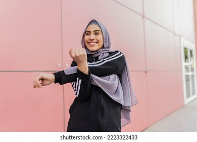 Happy arab muslim woman exercising. Islamic fitness female training outdoors - Powered by Shutterstock