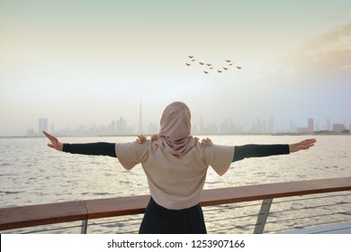 Happy Arab Woman Look At Dubai Skyline, Dubai City View, Wearing Abaya And Hijab