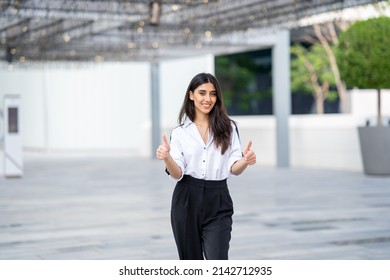 Happy Arab Woman Thumbs Up. Businesswoman Excited Full Body Looking Young North African Or Indian Standing In Business Background