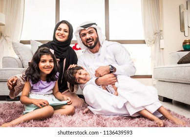Happy arabian family having fun at home