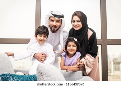 Happy arabian family having fun at home