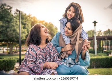 Happy Arabian Family Having Fun In Dubai - Mom Together With Her Daughters In A Park