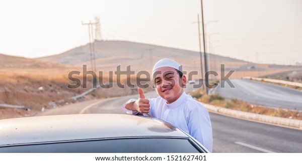 happy arabic family outside the car window waving
at each other