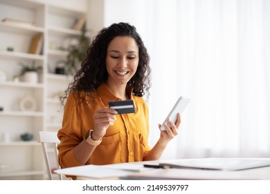 Happy Arabic Female Shopping Online Using Cellphone Making Payment Via Mobile Banking App Sitting At Desk In Office. Internet Commerce And Consumerism Concept - Powered by Shutterstock