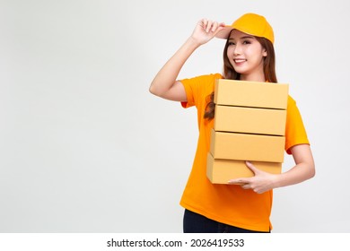 Happy Asia Delivery Woman In Orange Uniform Holding Package Parcel Box Isolated On White Background, Delivery Courier And Shipping Service Concept