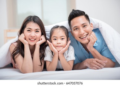 A Happy Asia Family With Kids In The Living.