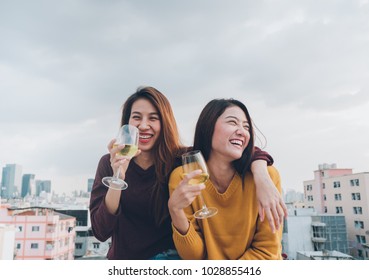 Happy Asia Girl Friends Enjoy Laughing And Cheerful Sparkling Wine Glass At Rooftop Party,Holiday Celebration Festive,teeage Lifestyle,freedom And Fun.lesbian Couple