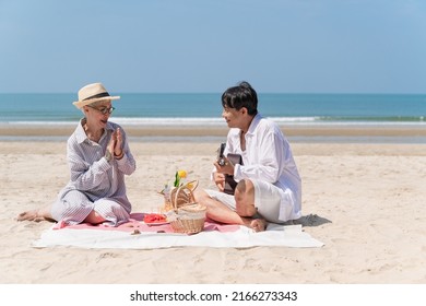 Happy Asia Senior Couple Picnic On The Beach