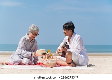 Happy Asia Senior Couple Picnic On The Beach