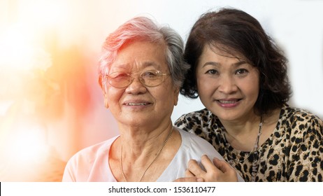 
Happy Asia Senior Mother And Adult Daughter Concept. Portrait Of Asian Family Older Ageing Women And Caregiver Smiling With Happiness At Home, Or Wellbeing County  Hospice.