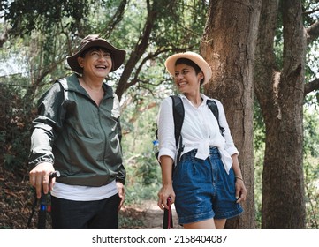 Happy Asian Adult Couple Trekking In The Wood