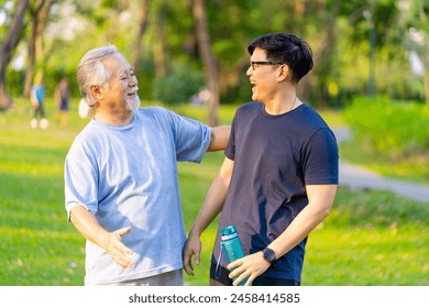 Happy Asian adult son and elderly father jogging exercise together at park. Retired man with outdoor lifestyle sport workout in the city. Family relationship and senior people health care concept. - Powered by Shutterstock