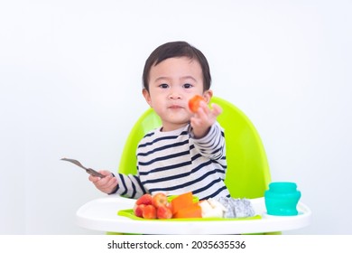 Happy Asian Baby Sitting In A Children Chair With Fruit, Healthy Food Concept.