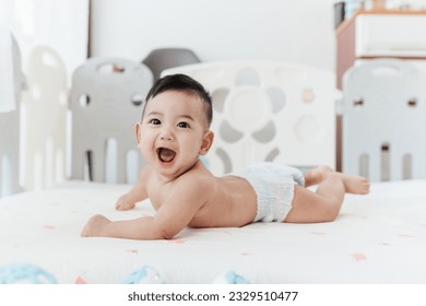 Happy Asian baby start to crawling on a bed at home, Adorable development 5 months old. Baby healthcare hygiene concept. - Powered by Shutterstock