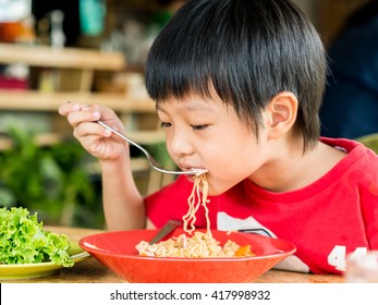 Happy Asian Boy Eating Delicious Noodle