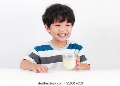 Happy Asian boy with a glass of milk, Isolated over white background. - Powered by Shutterstock