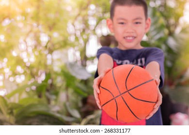 Happy Asian Boy Holding Basketball